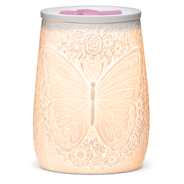 Flight of the Monarch Scentsy Warmer lit up and glowing with wax in dish